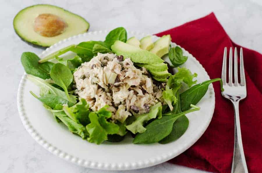 tuna salad on a bed of greens with avocado