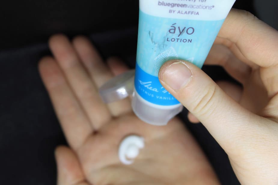 view of person's hand squeezing lotion onto their other palm from a tube